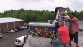 gif pinball Mario Andretti getting pushed off a roof by TNT.gif